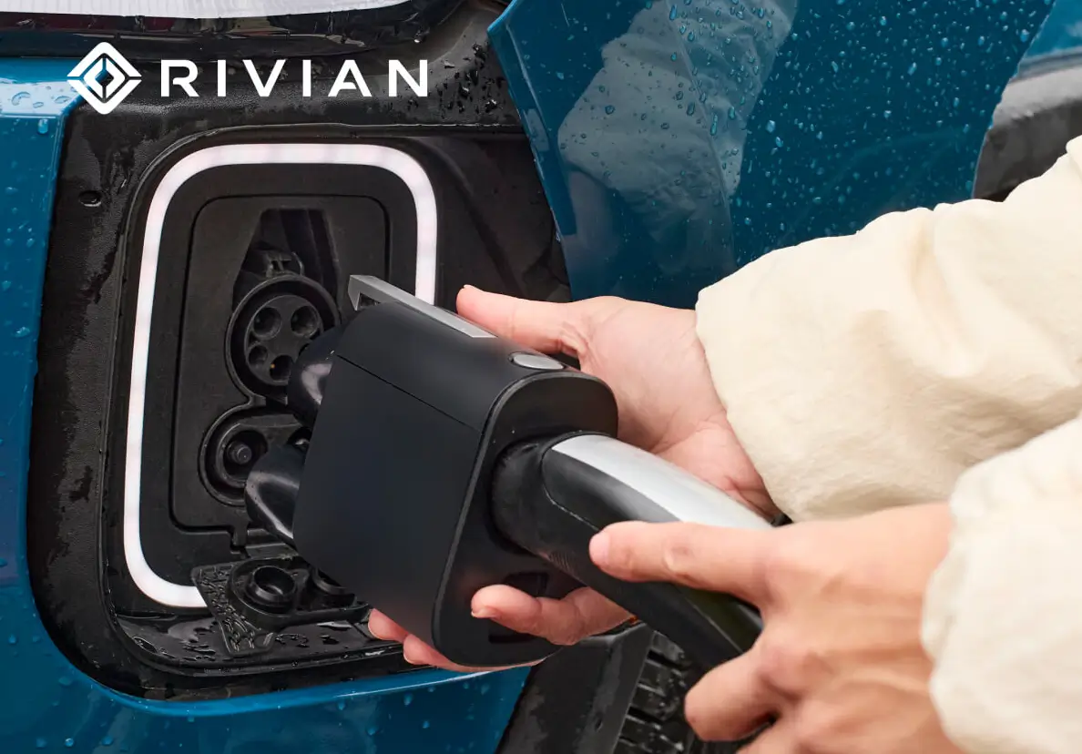 Customer plugging in NACS adapter into Rivian